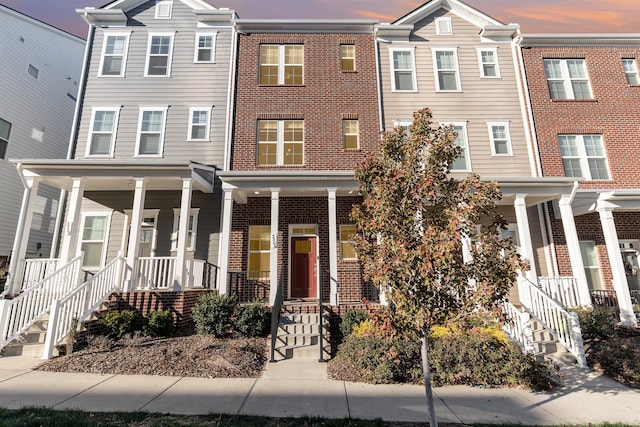 view of property featuring covered porch