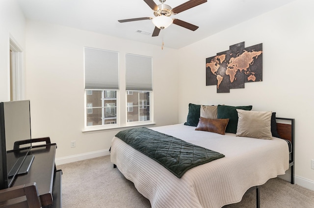 bedroom featuring light colored carpet and ceiling fan