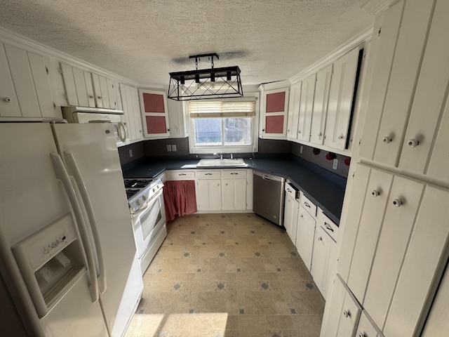 1200 N Church St, Portland, TN 37148 - kitchen featuring white appliances, dark countertops, a textured ceiling, white cabinets, and light flooring