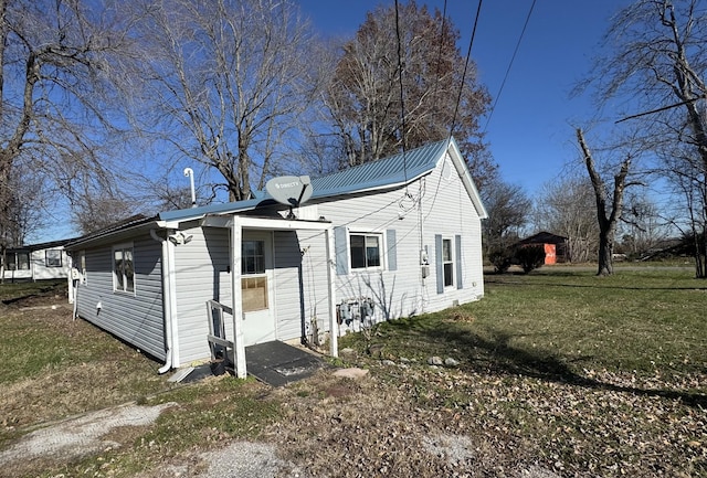 back of property featuring a lawn