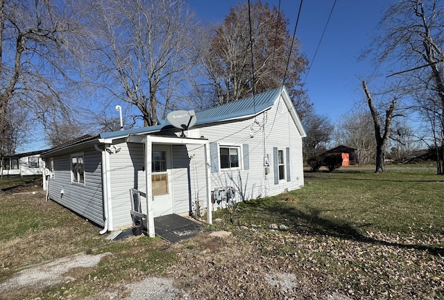 1200 N Church St, Portland, TN 37148 - view of side of home featuring a lawn and a metal roof