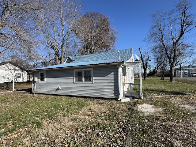 1200 N Church St, Portland, TN 37148 - view of side of property with a metal roof and a yard