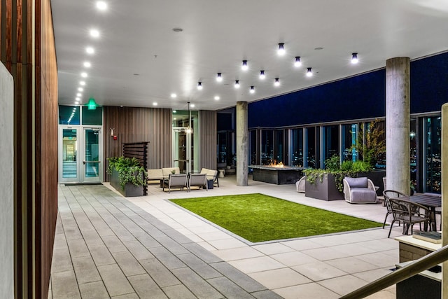 rear view of house with outdoor lounge area, a patio, and french doors