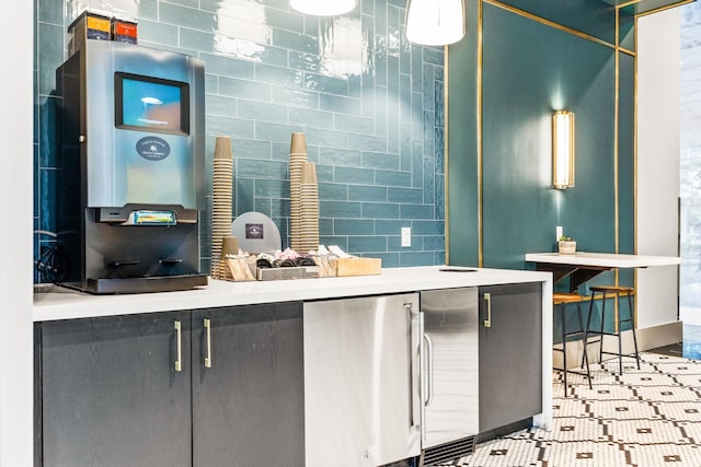 kitchen featuring stainless steel fridge and tile walls