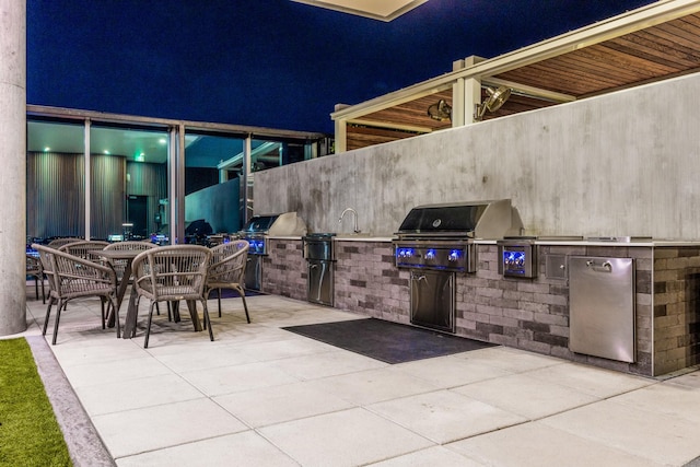 patio at night with area for grilling