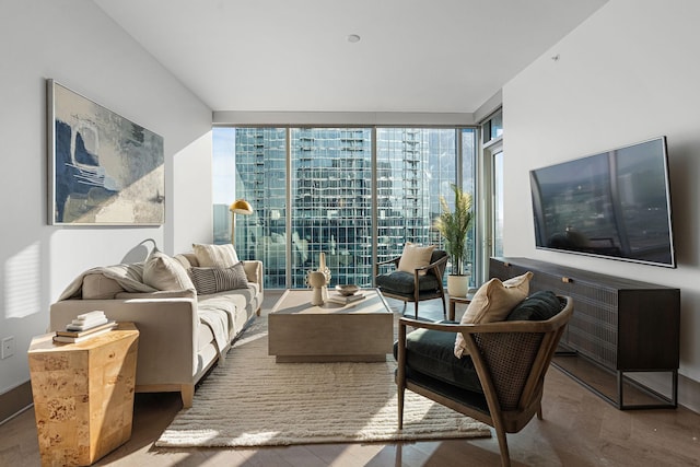 living room with a wealth of natural light, hardwood / wood-style floors, and expansive windows