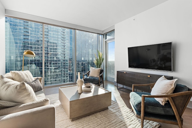 living room featuring wood-type flooring and floor to ceiling windows