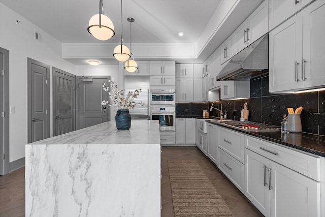 kitchen with a kitchen island, white cabinetry, and appliances with stainless steel finishes