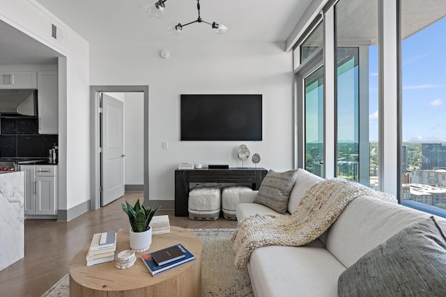 1616 W End Ave Unit 2011, Nashville, TN 37203 - living room featuring healthy amount of natural light, a chandelier, and wood finished floors