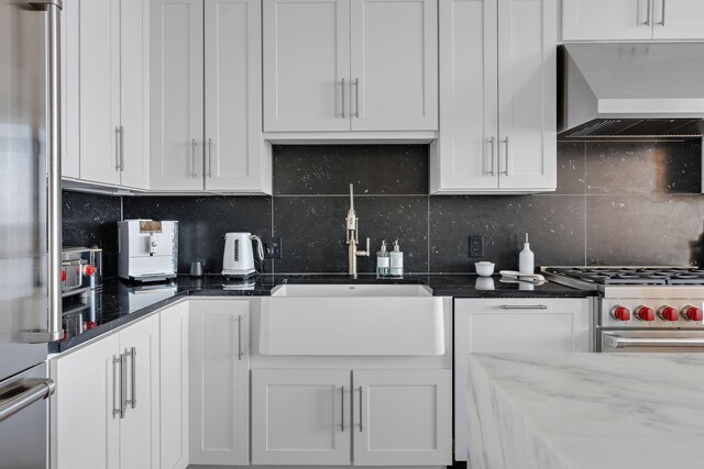 1616 W End Ave Unit 2011, Nashville, TN 37203 - kitchen with custom range hood, appliances with stainless steel finishes, backsplash, and white cabinets