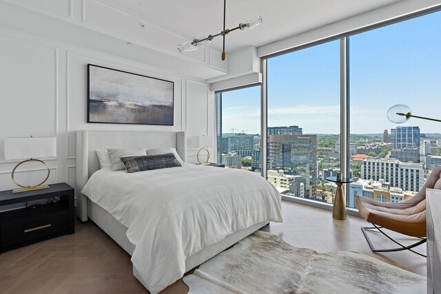 bedroom with parquet flooring and multiple windows