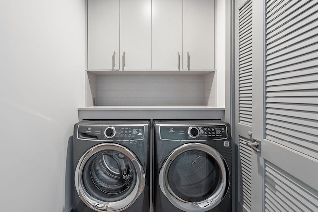 1616 W End Ave Unit 2011, Nashville, TN 37203 - laundry area featuring washing machine and dryer and cabinet space