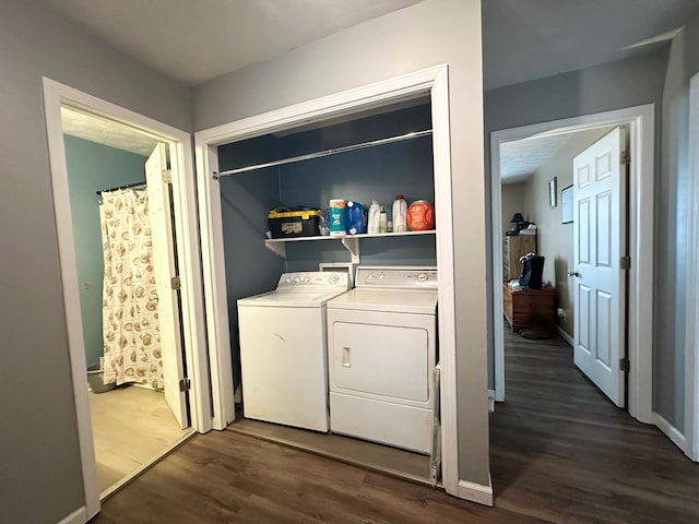 clothes washing area featuring washer and dryer and dark hardwood / wood-style floors