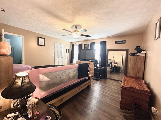 bedroom with a textured ceiling, dark hardwood / wood-style flooring, and ceiling fan