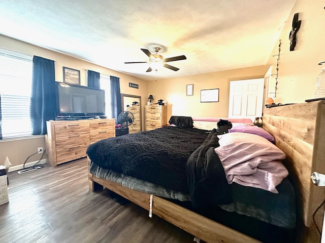 bedroom with ceiling fan and dark hardwood / wood-style flooring