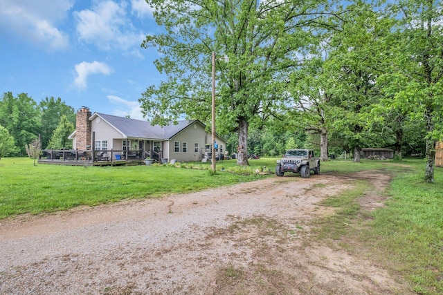 exterior space with a front yard and a wooden deck