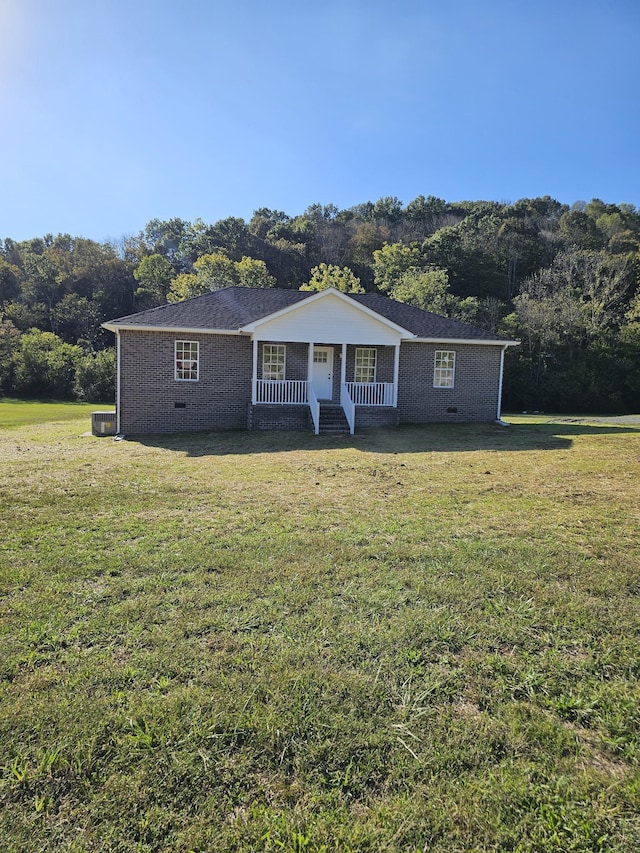 ranch-style house featuring a porch, central air condition unit, and a front lawn