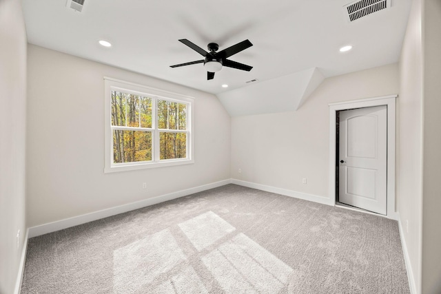 interior space with light carpet, vaulted ceiling, and ceiling fan