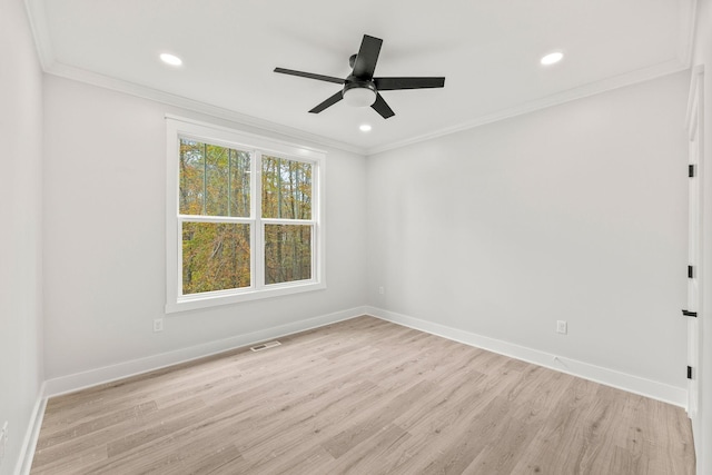 spare room featuring light hardwood / wood-style flooring, ceiling fan, and crown molding