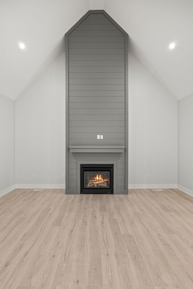 interior space with light hardwood / wood-style floors and vaulted ceiling