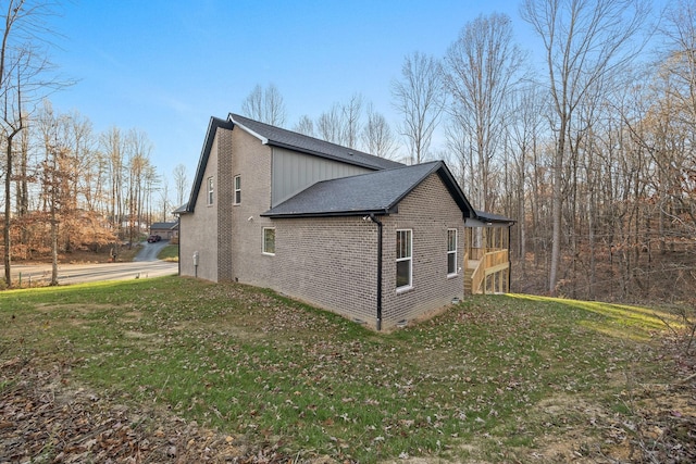 view of side of property with a lawn