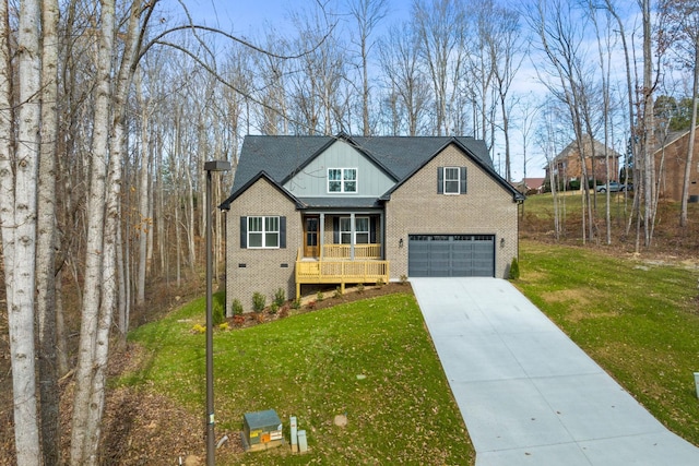 view of front of property with covered porch, a garage, and a front lawn