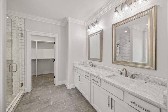 bathroom featuring tile patterned floors, vanity, a shower with shower door, and crown molding