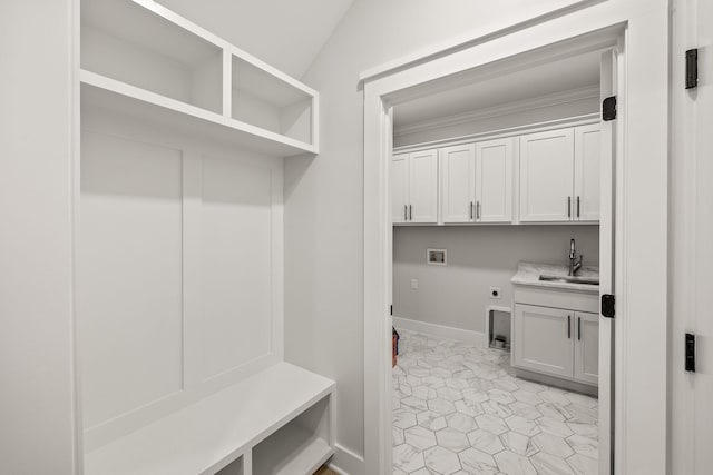 mudroom with sink, light tile patterned floors, and lofted ceiling