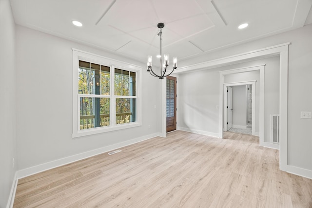 unfurnished dining area featuring light hardwood / wood-style flooring and a notable chandelier