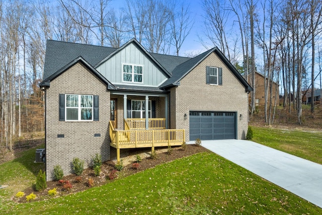 view of front of home featuring central air condition unit, a front lawn, a porch, and a garage