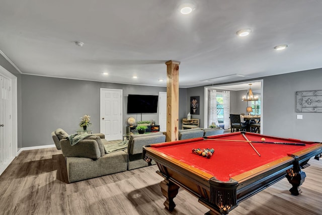 game room featuring ornate columns, wood-type flooring, a notable chandelier, and pool table