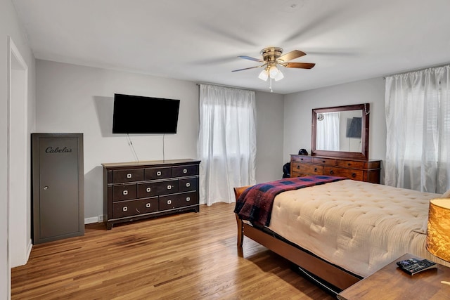 bedroom with light hardwood / wood-style flooring and ceiling fan