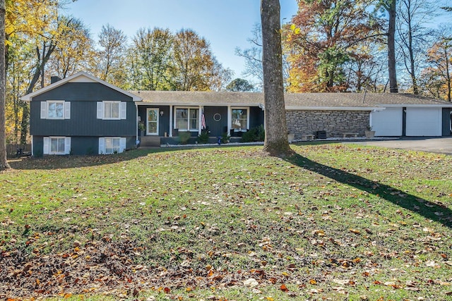 split level home featuring a front lawn and a garage