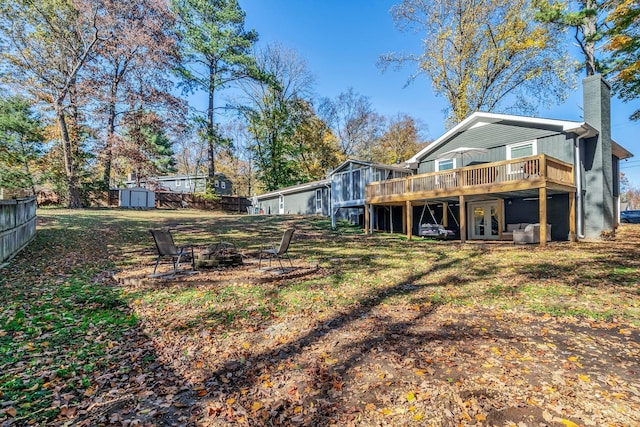 view of yard with a shed, an outdoor fire pit, and a wooden deck