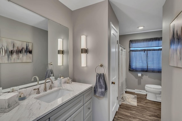 bathroom with vanity, hardwood / wood-style flooring, and toilet