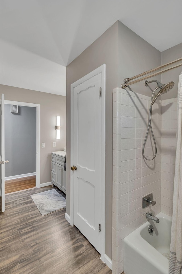 bathroom featuring vanity, shower / tub combo, and hardwood / wood-style flooring