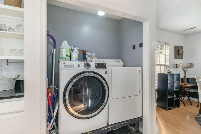 laundry room featuring hardwood / wood-style floors and washer and dryer