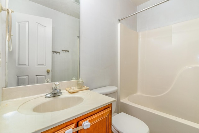 full bathroom with bathing tub / shower combination, vanity, and toilet