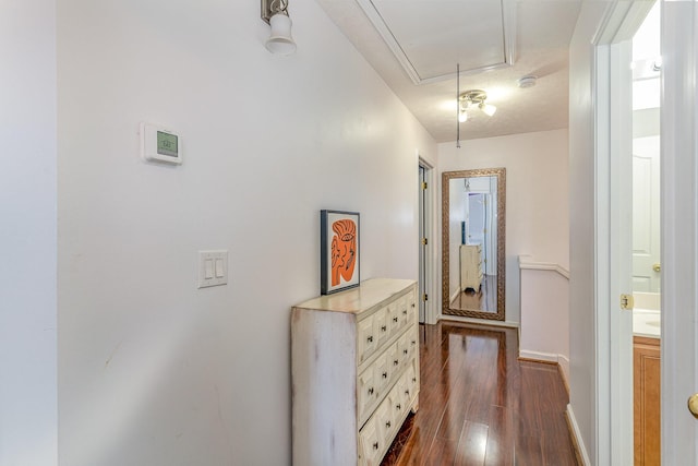 hall featuring a textured ceiling and dark hardwood / wood-style floors