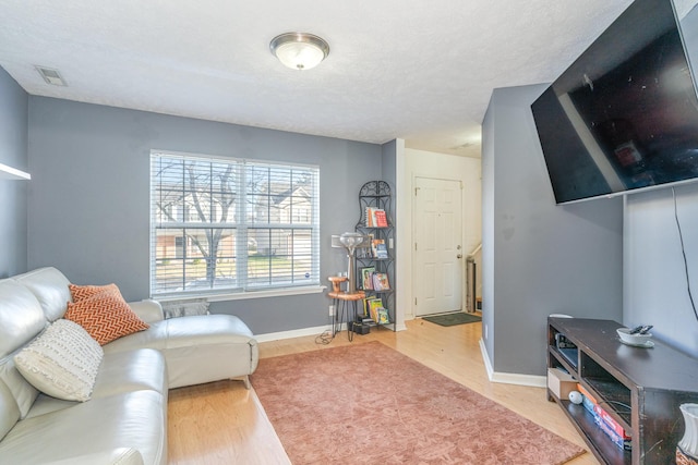 living area featuring hardwood / wood-style floors and a textured ceiling