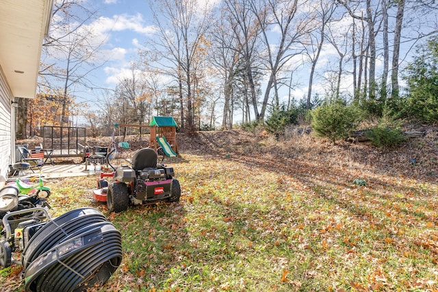 view of yard featuring a playground and a patio