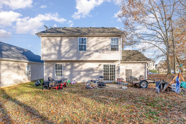 rear view of property featuring a yard and a patio