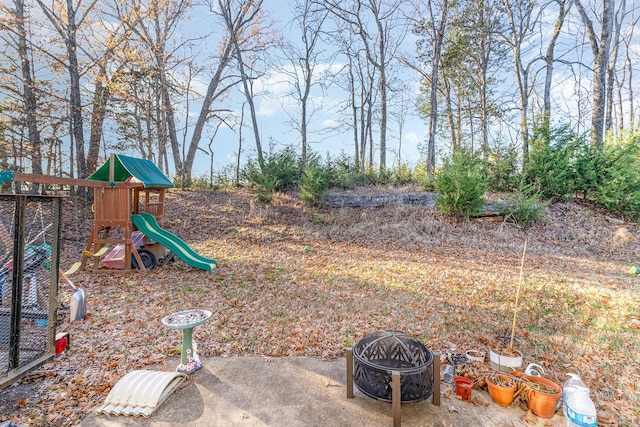 view of yard featuring a fire pit and a playground