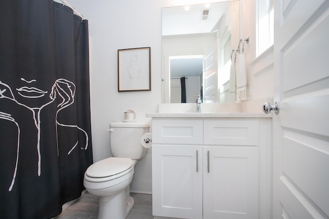 bathroom featuring vanity and toilet