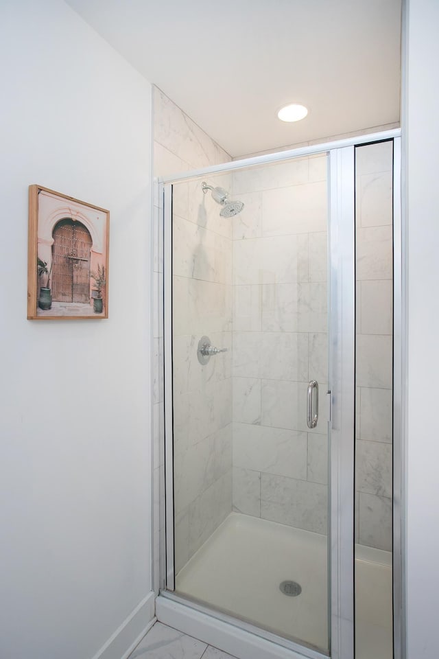 bathroom with a shower with shower door