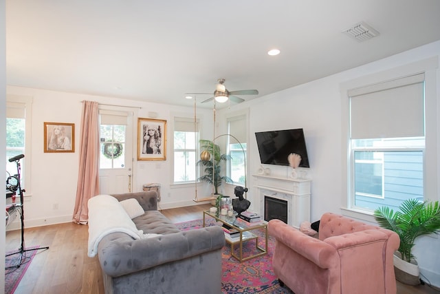 living room with ceiling fan and light wood-type flooring