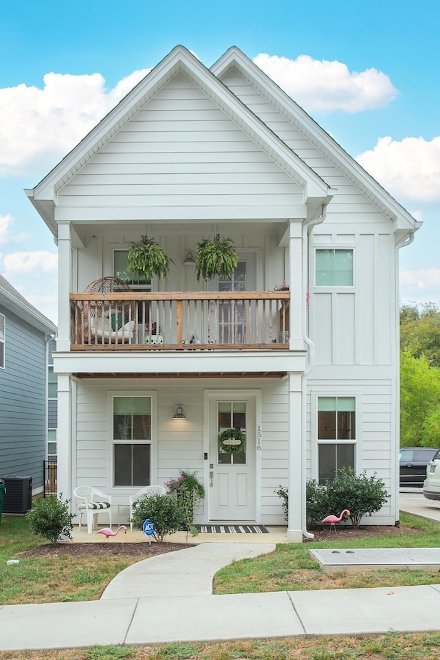 view of front facade featuring a balcony and central AC