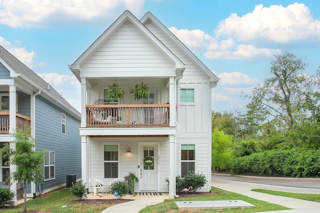 view of front of property with a balcony and cooling unit