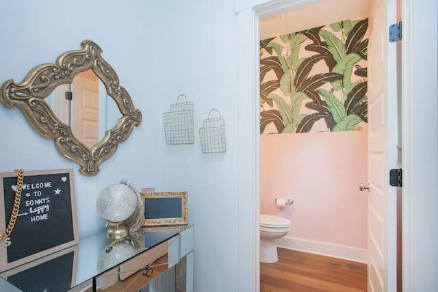 bathroom with toilet and hardwood / wood-style flooring