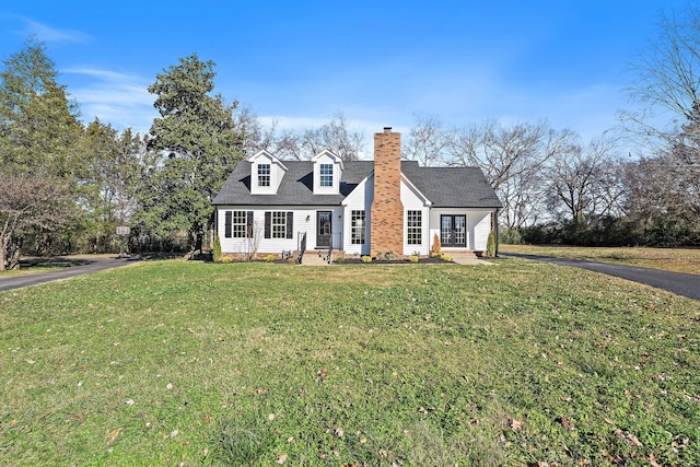 new england style home with a front lawn